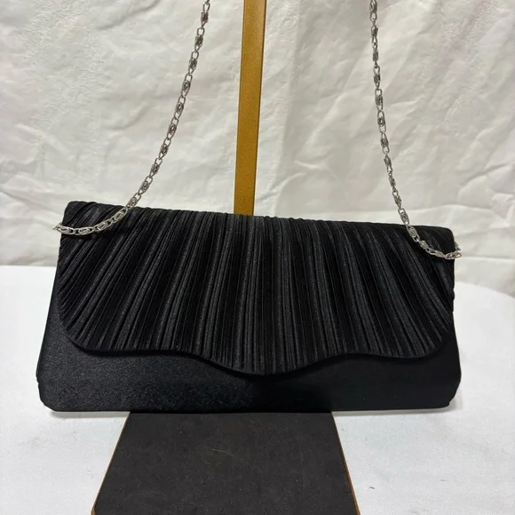 black pleated evening clutch bag with a detachable silver-tone chain strap. - Picture 1 of 5